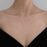 Model wearing the Crystal Accent Necklace with a black off-shoulder top, minimalistic styling