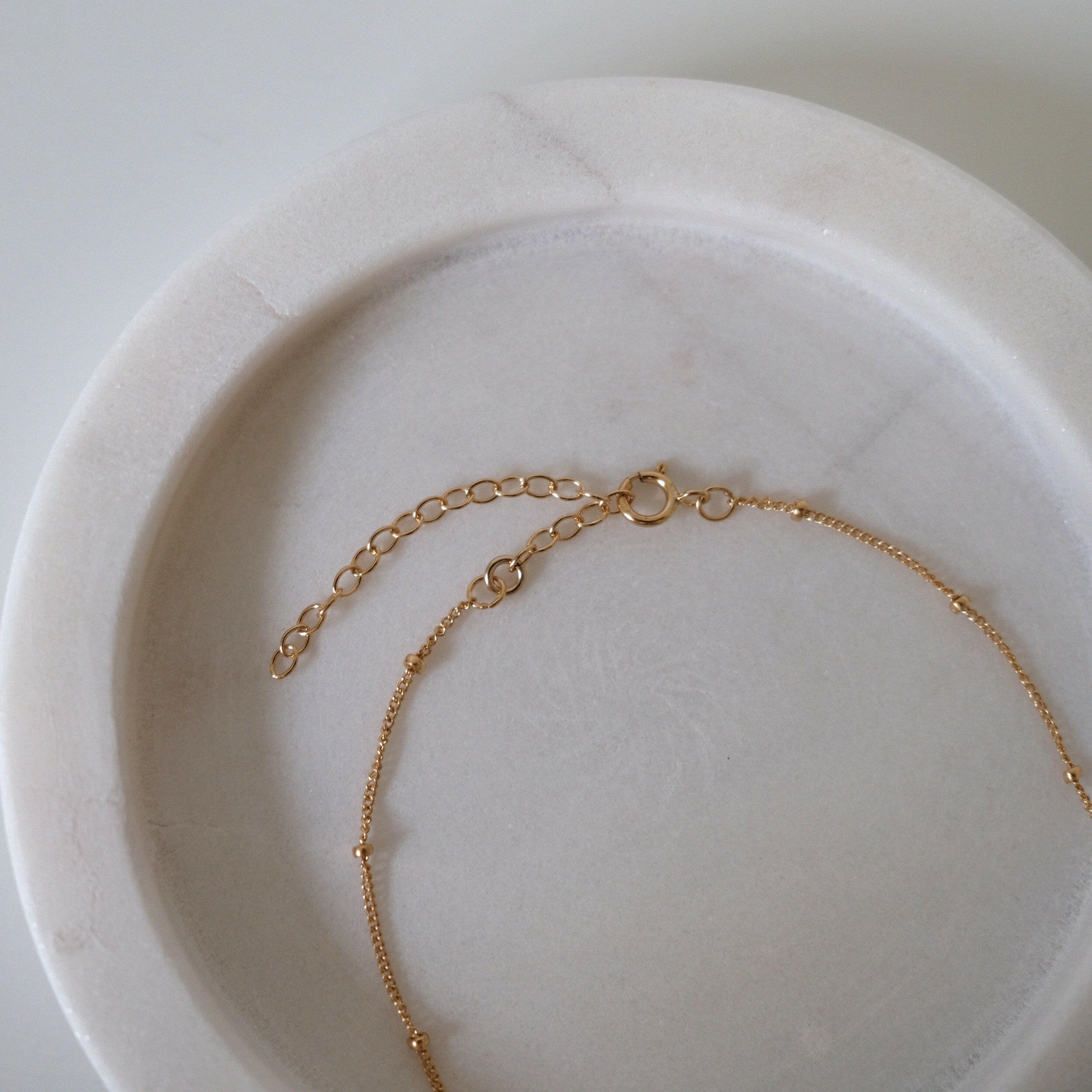 Spring ring clasp detail showing secure and delicate closure