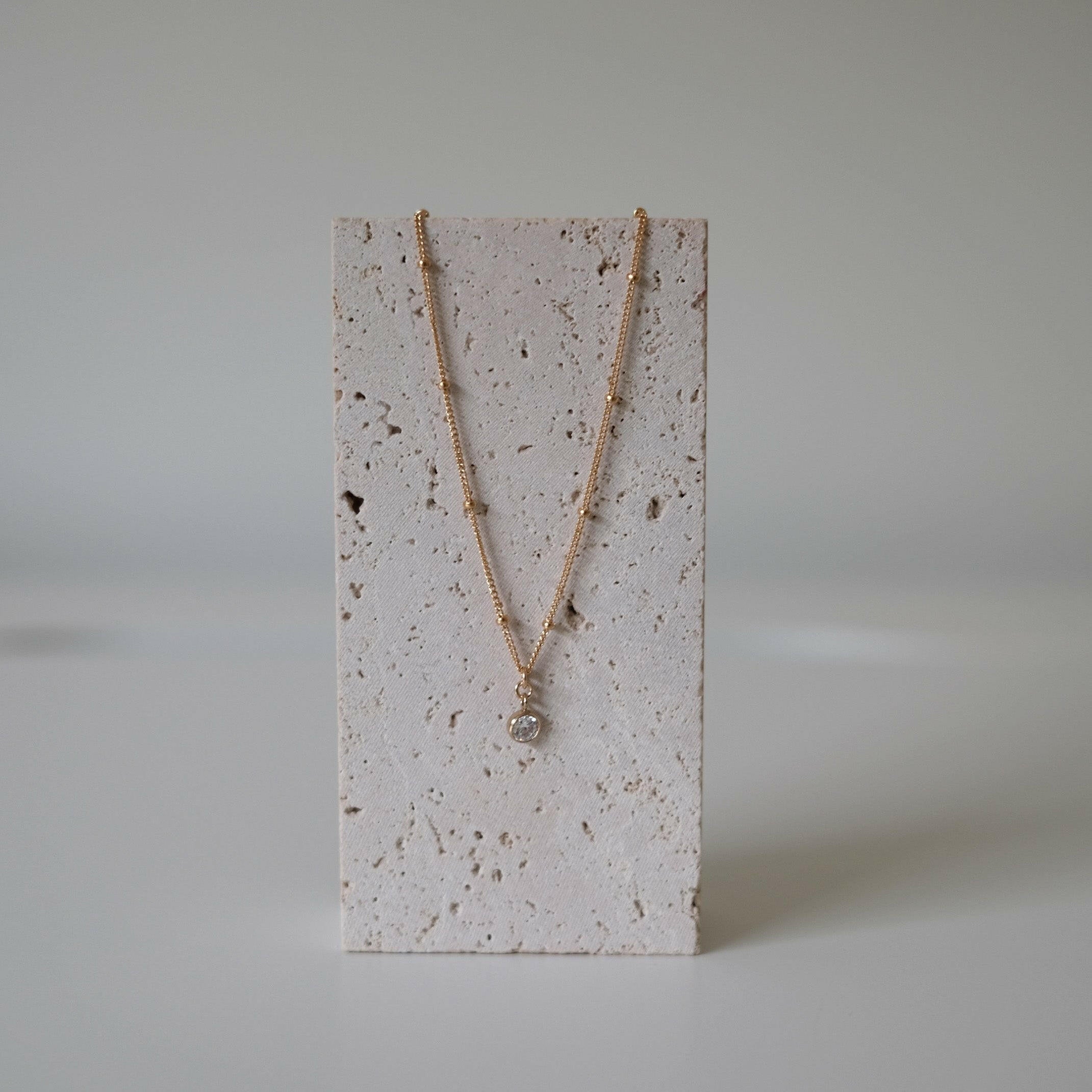 Stone stand display of necklace chain curve and center crystal