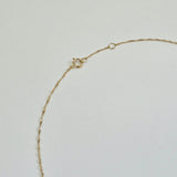 Detailed view of spring clasp and O-ring on a 14K gold necklace, showing clean finish and secure mechanism