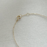 Close-up of the 14K Diamond Accent Bracelet’s spring ring clasp and fine gold chain links