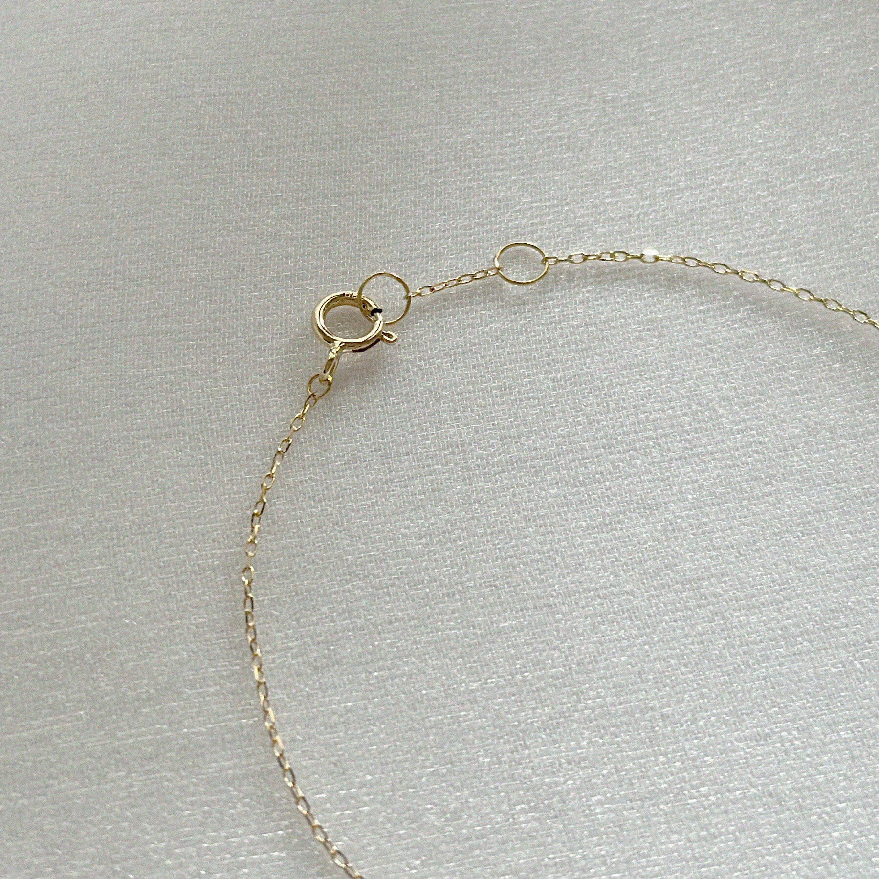 Close-up of the 14K Diamond Accent Bracelet’s spring ring clasp and fine gold chain links