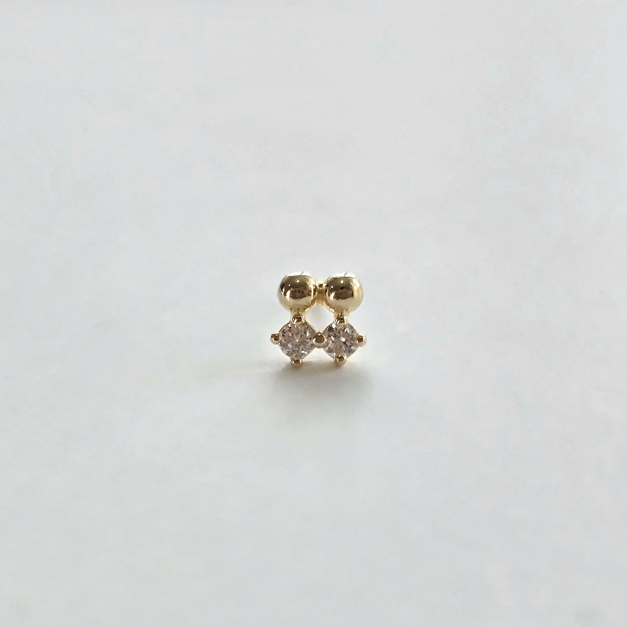Front view of 14K Crystal Twin Cartilage Earring on white background