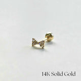 Side view of bow-shaped cartilage earring on white background