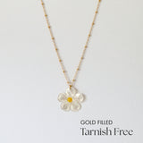 Gold filled daisy necklace with large mother of pearl pendant laid flat