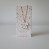 Necklace displayed on stone display with pendant centered