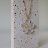 Ultra close-up of mother of pearl daisy necklace