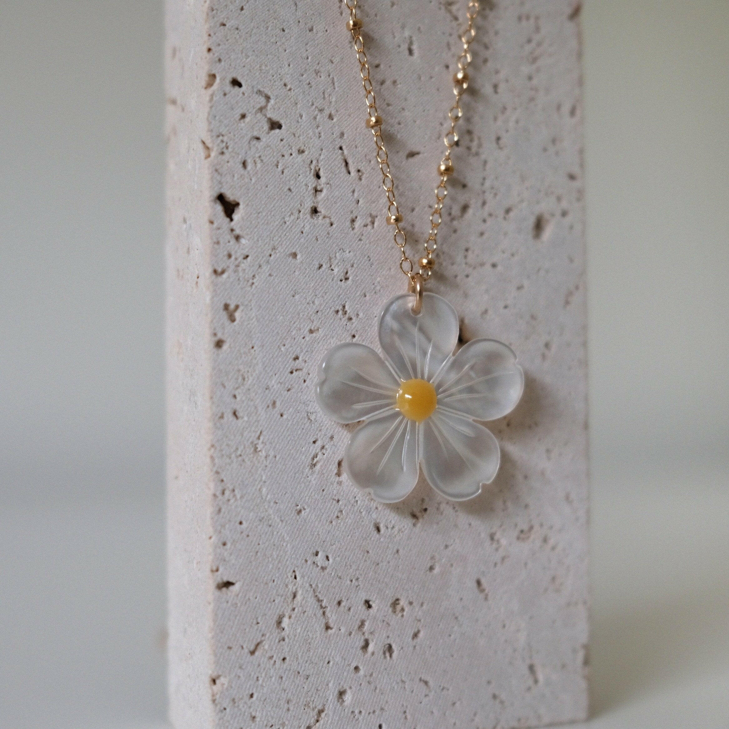 Ultra close-up of mother of pearl daisy necklace