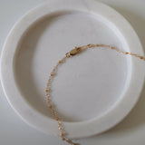 Side view showing chain connection to pendant and lobster clasp
