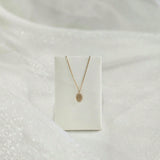 Dear Initial Necklace draped over a necklace holder for display