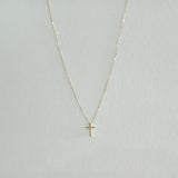 Symmetrical display of gold necklace showcasing detailed pendant and chain