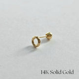 Side view of 14K gold donut cartilage earring on white background
