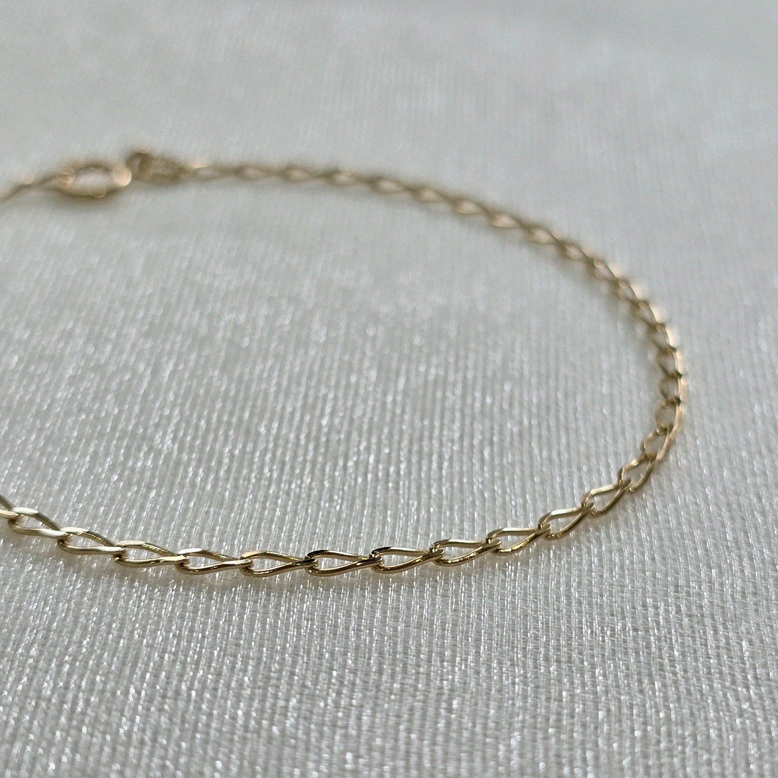 Close-up of 14K gold chain construction and fine link design