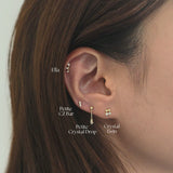 Petite CZ Bar Earring layered with other crystal cartilage and studs in a curated ear stack