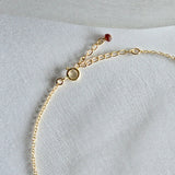 Close-up of 2–3mm natural stones on chain with spring clasp
