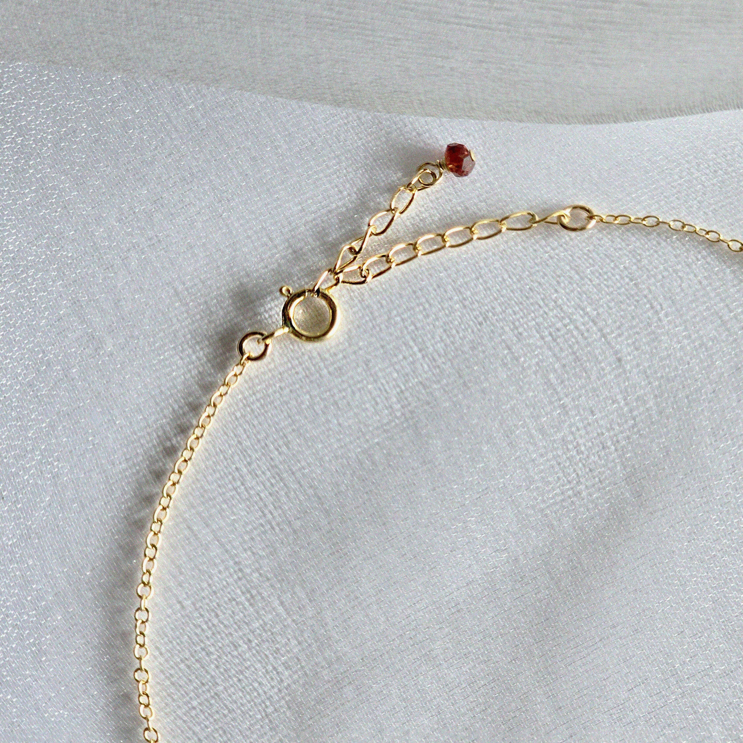 Close-up of 2–3mm natural stones on chain with spring clasp