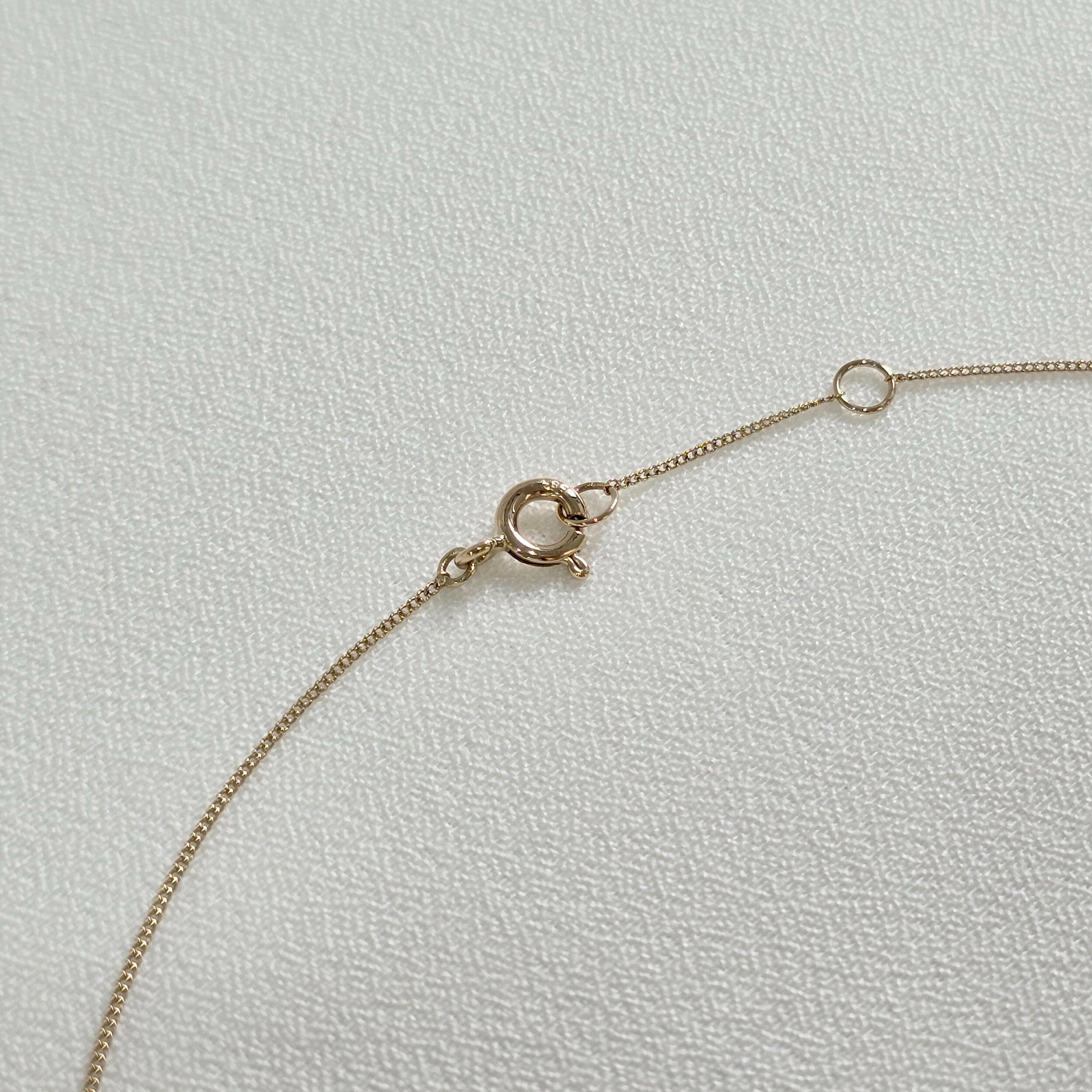 Detail view of 14K gold chain with spring clasp and fine link finish on Gleam Crystal Necklace