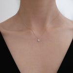 Model wearing Gleam Crystal Necklace with marquise halo pendant for refined everyday styling