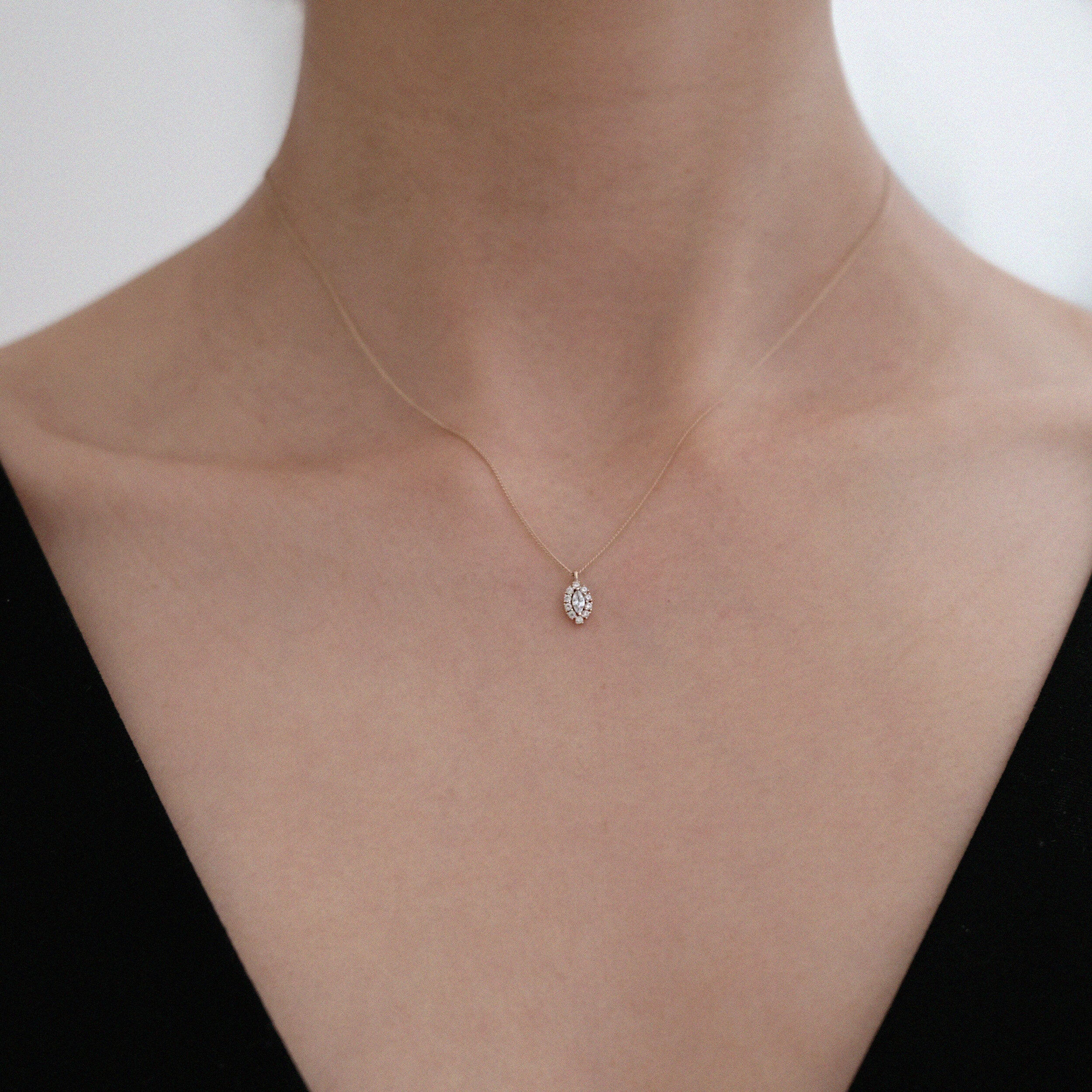 Model wearing Gleam Crystal Necklace with marquise halo pendant for refined everyday styling