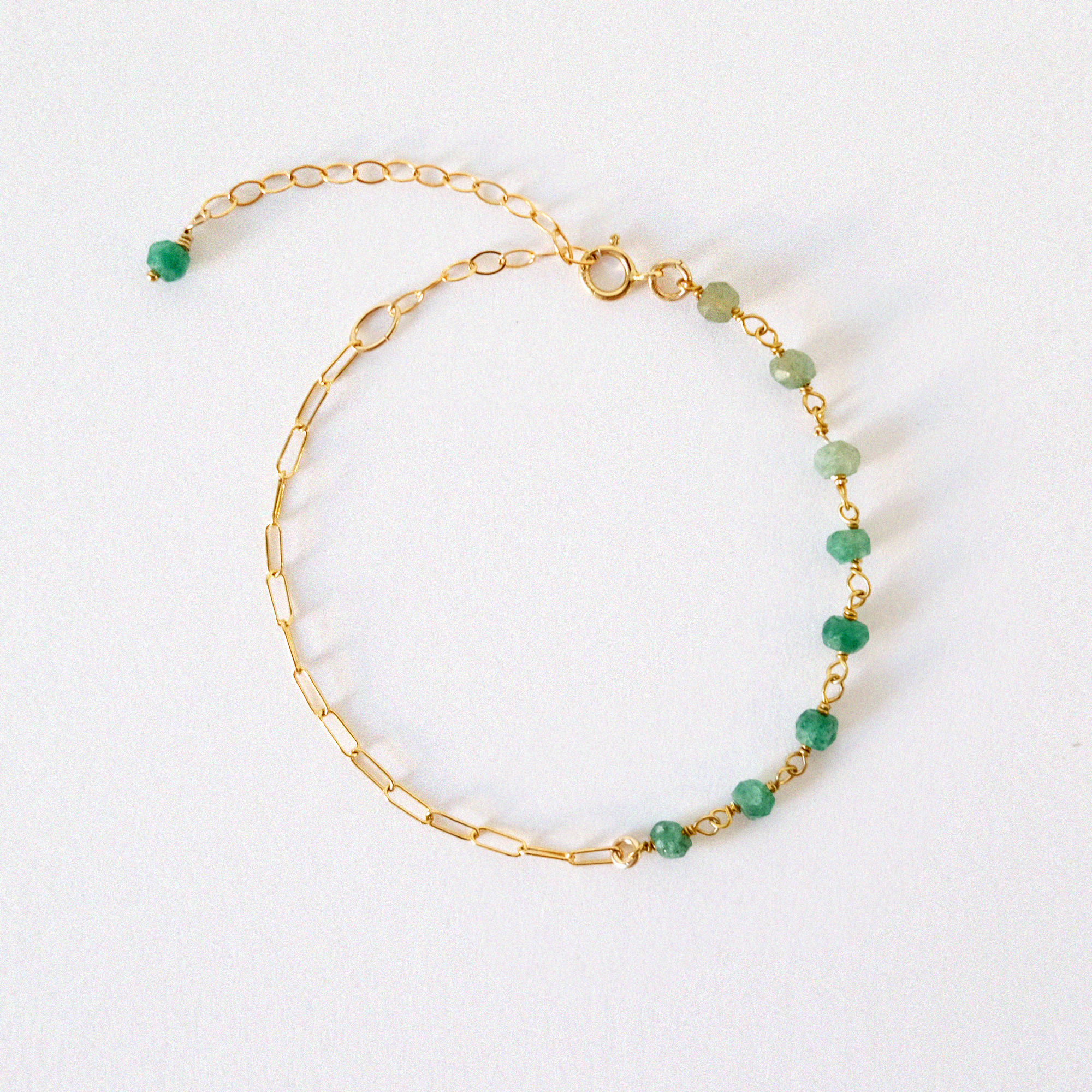 Bracelet stack featuring aventurine and bold gold link chains