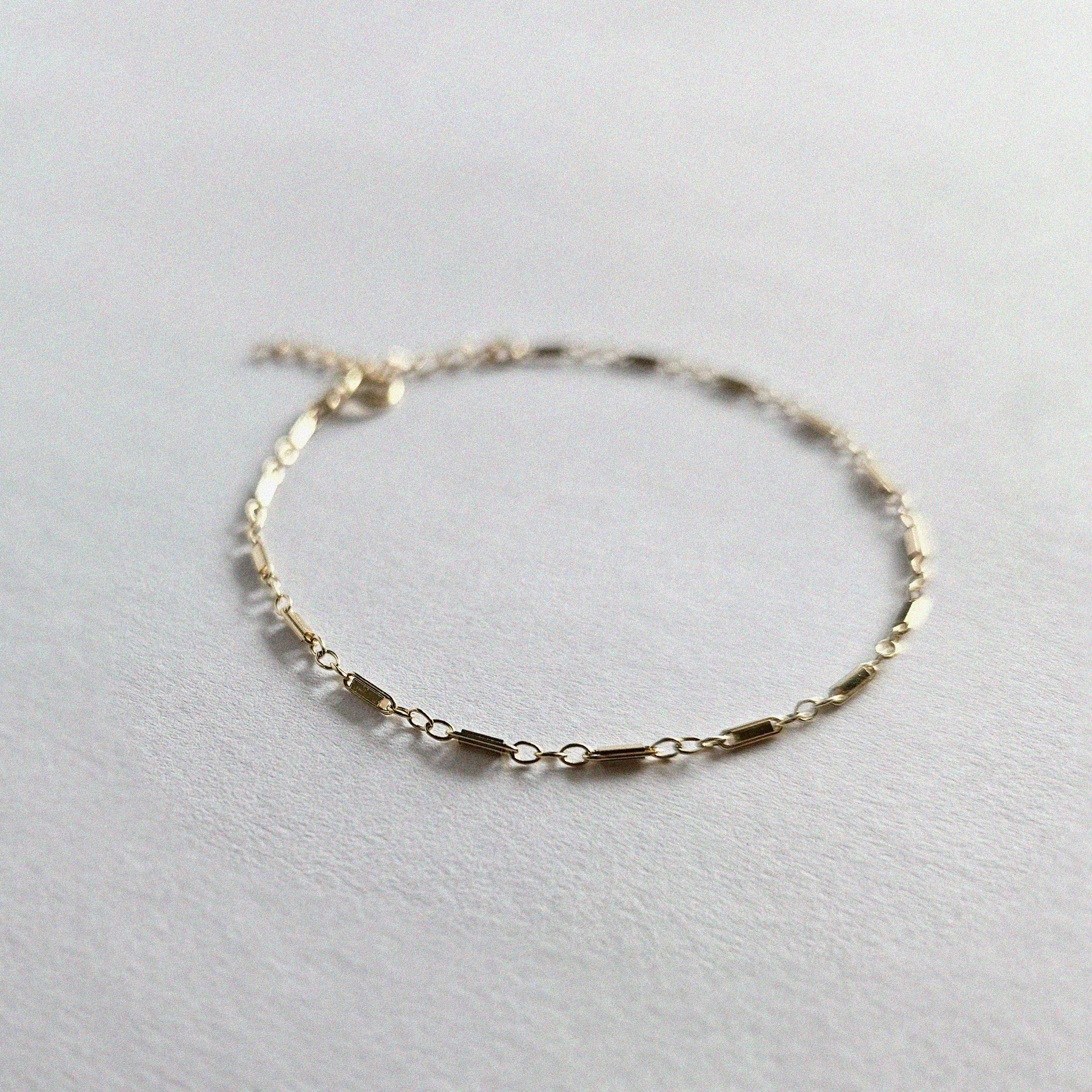 Macro shot showing textured chain links of Bonbon Bracelet