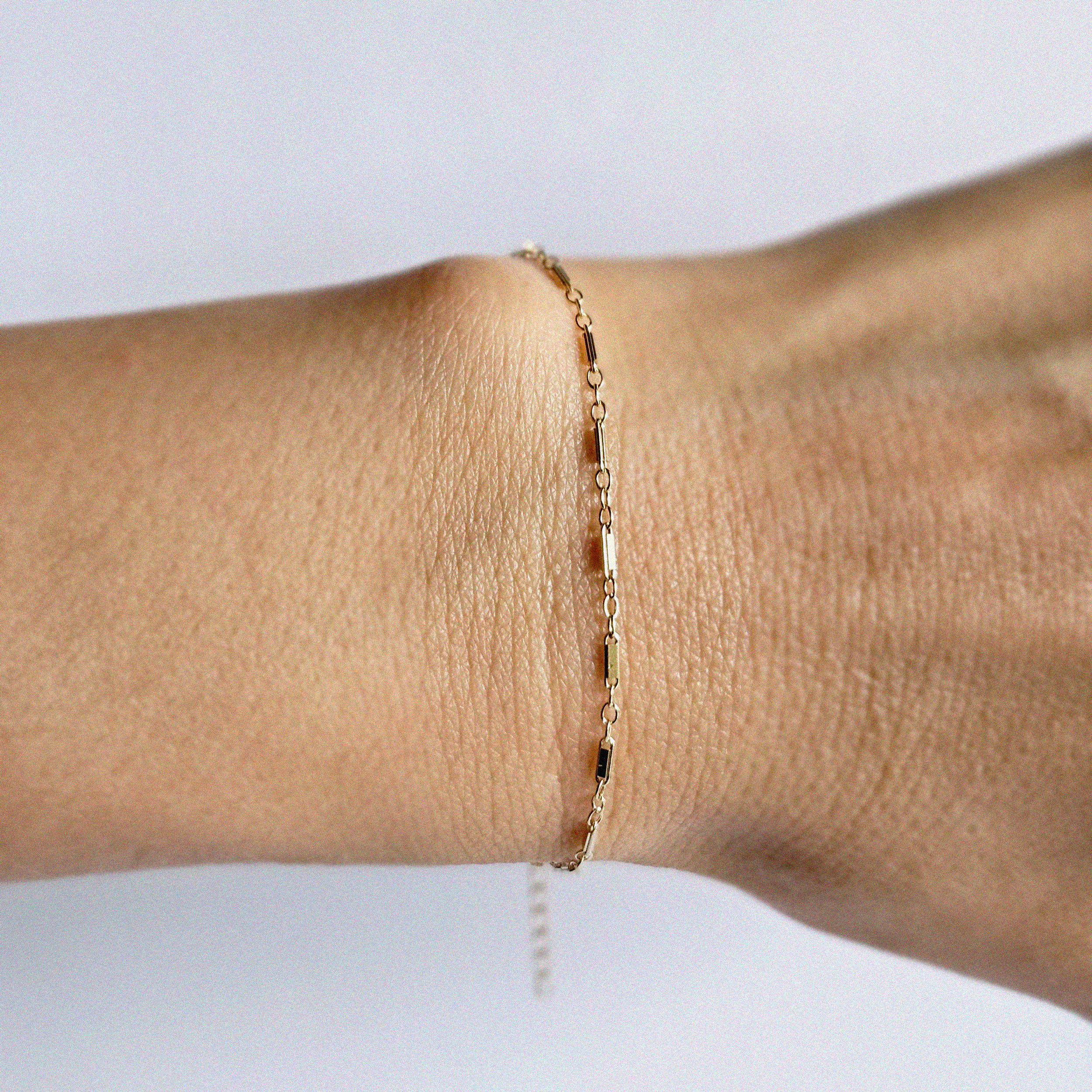 Top view of wrist featuring unique gold bracelet with subtle shine