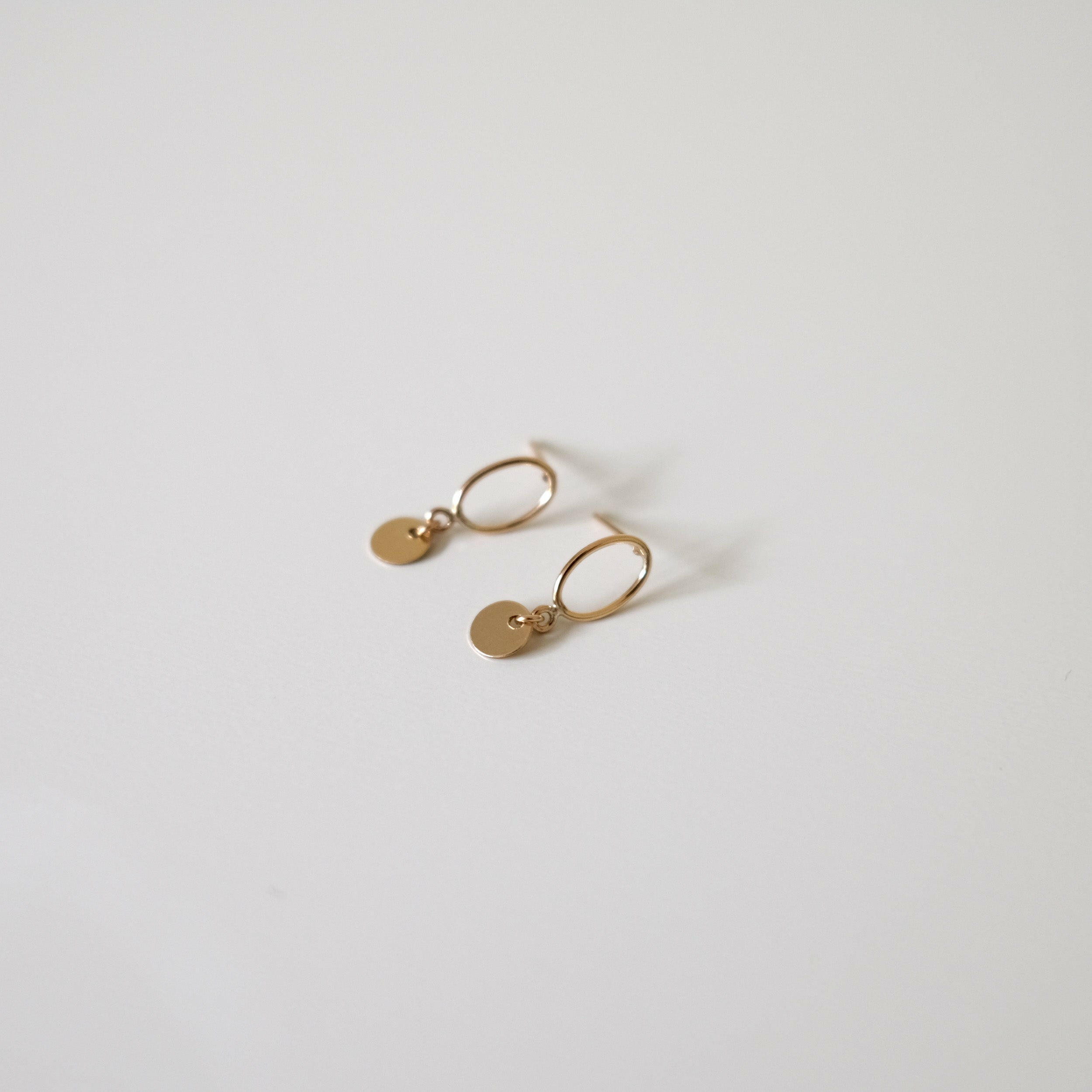 Side profile of Celina Disc Earrings highlighting flat disc shape