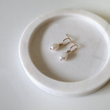 Gold Filled Celina Pearl Earrings displayed on soft pink tray