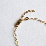 Zoomed-in image of lobster clasp and extension chain on coffee bean bracelet