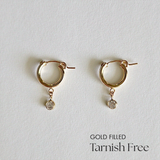 Crystal Flex Hoops in front view, featuring centered cubic zirconia on gold-filled hoops