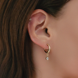 Model wearing Crystal Flex Hoops solo with natural lighting on earlobe