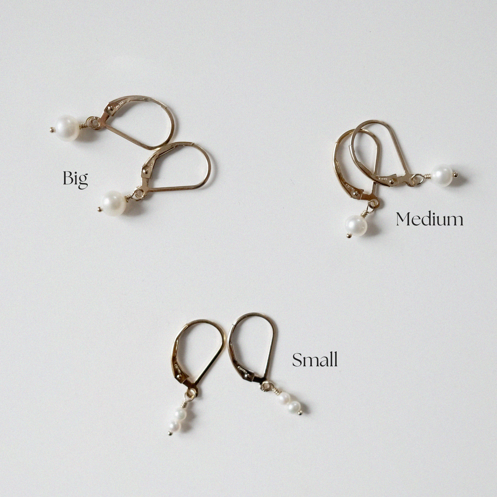 hree pairs of Olivia Pearl Earrings showcasing size variations in freshwater pearls