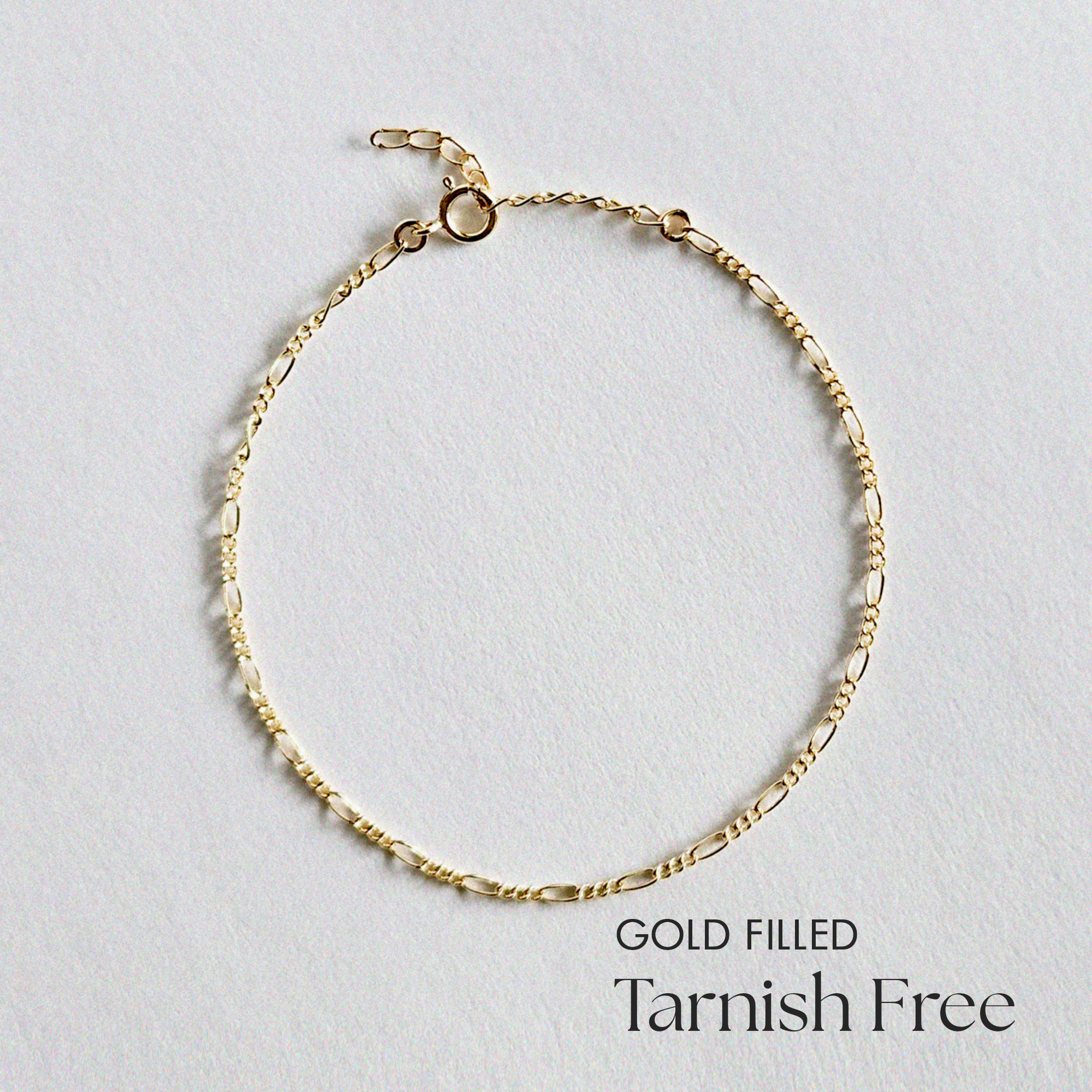Top-down view of S Figaro Bracelet showing fine gold Figaro chain