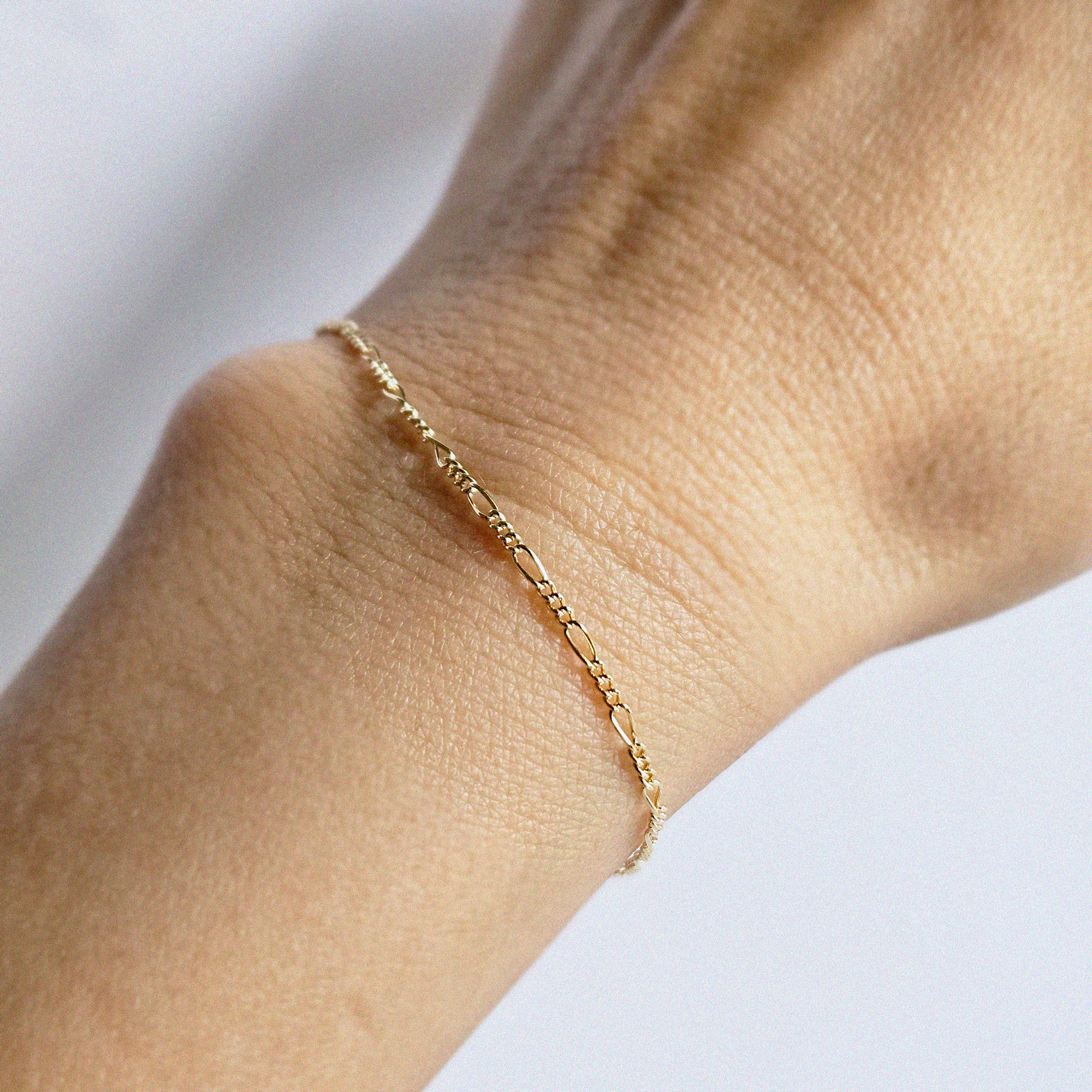 S Figaro Bracelet styled alone on model’s wrist from above