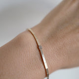 Close-up of the Grazia Bracelet showcasing a single diamond set in a fine 14K gold chain