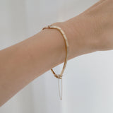 Model wearing the 14K Grazia Bracelet with diamond accent, featuring clasp chain detail