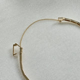 Detailed view of secure box clasp and gold safety chain on solid gold bracelet