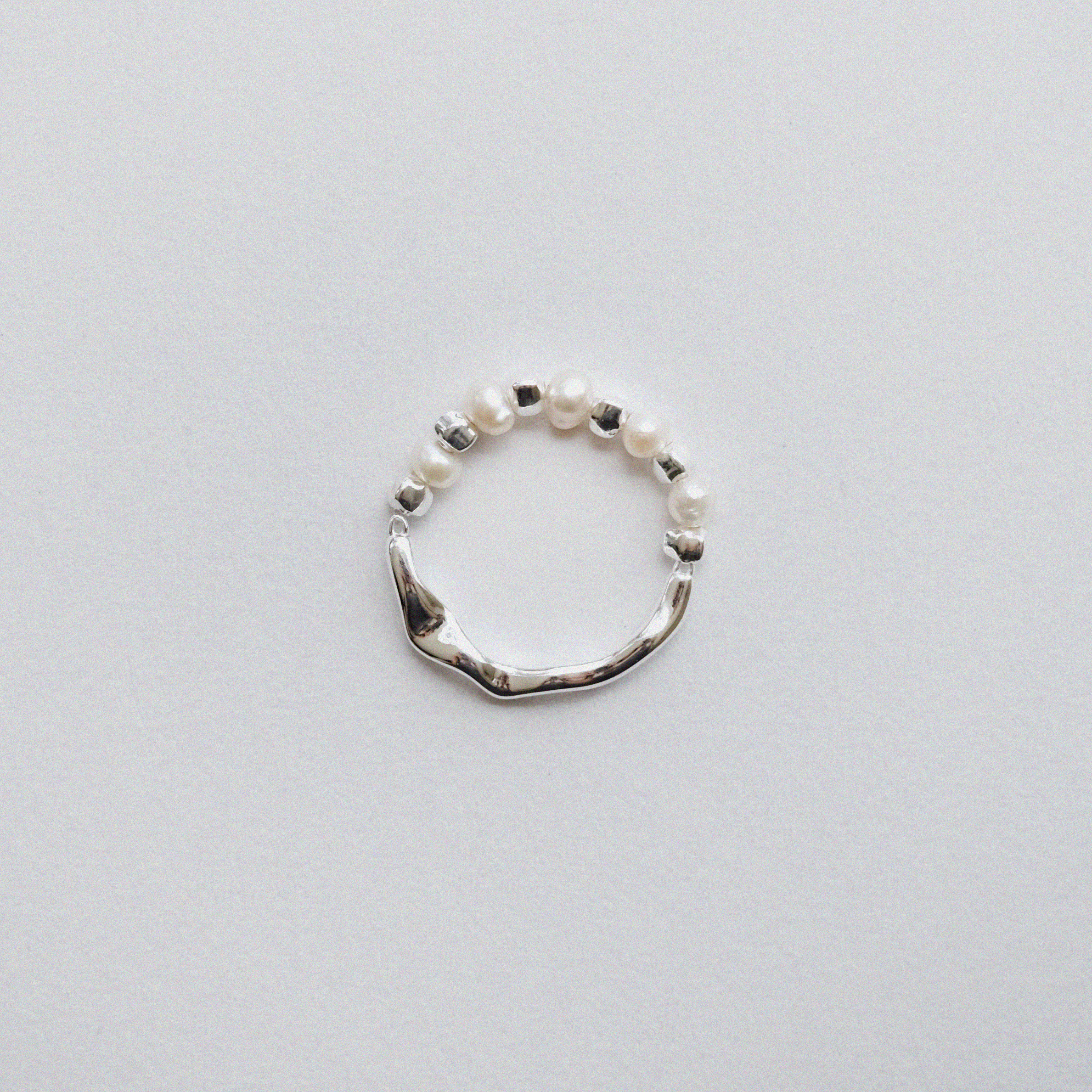 Handmade Sterling Silver beaded ring with freshwater pearl; reversible design with pearl on one side and grooved silver band on the other.