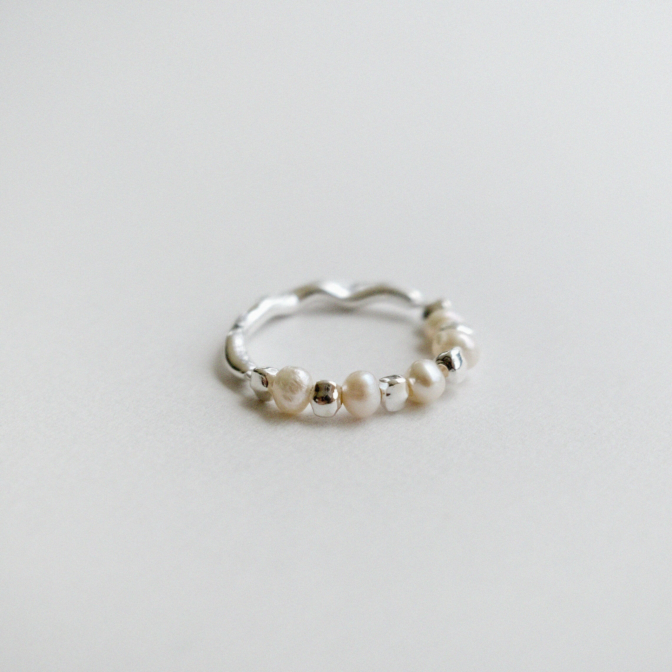 Handmade Sterling Silver beaded ring with freshwater pearl; reversible design with pearl on one side and grooved silver band on the other.