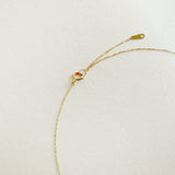Close-up of custom initial and 2.5mm diamond set on 14K gold pendant necklace