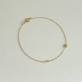 Personalized diamond bracelet featuring a polished gold letter H charm