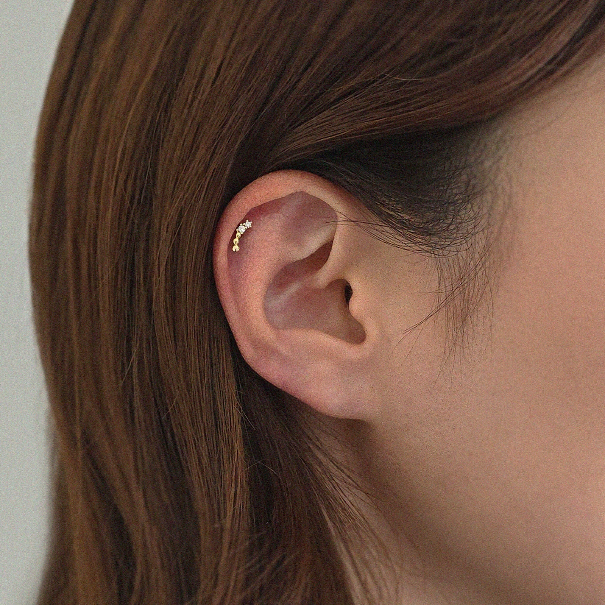 Jade Cartilage Earring styled solo in upper ear, highlighting clean gold finish