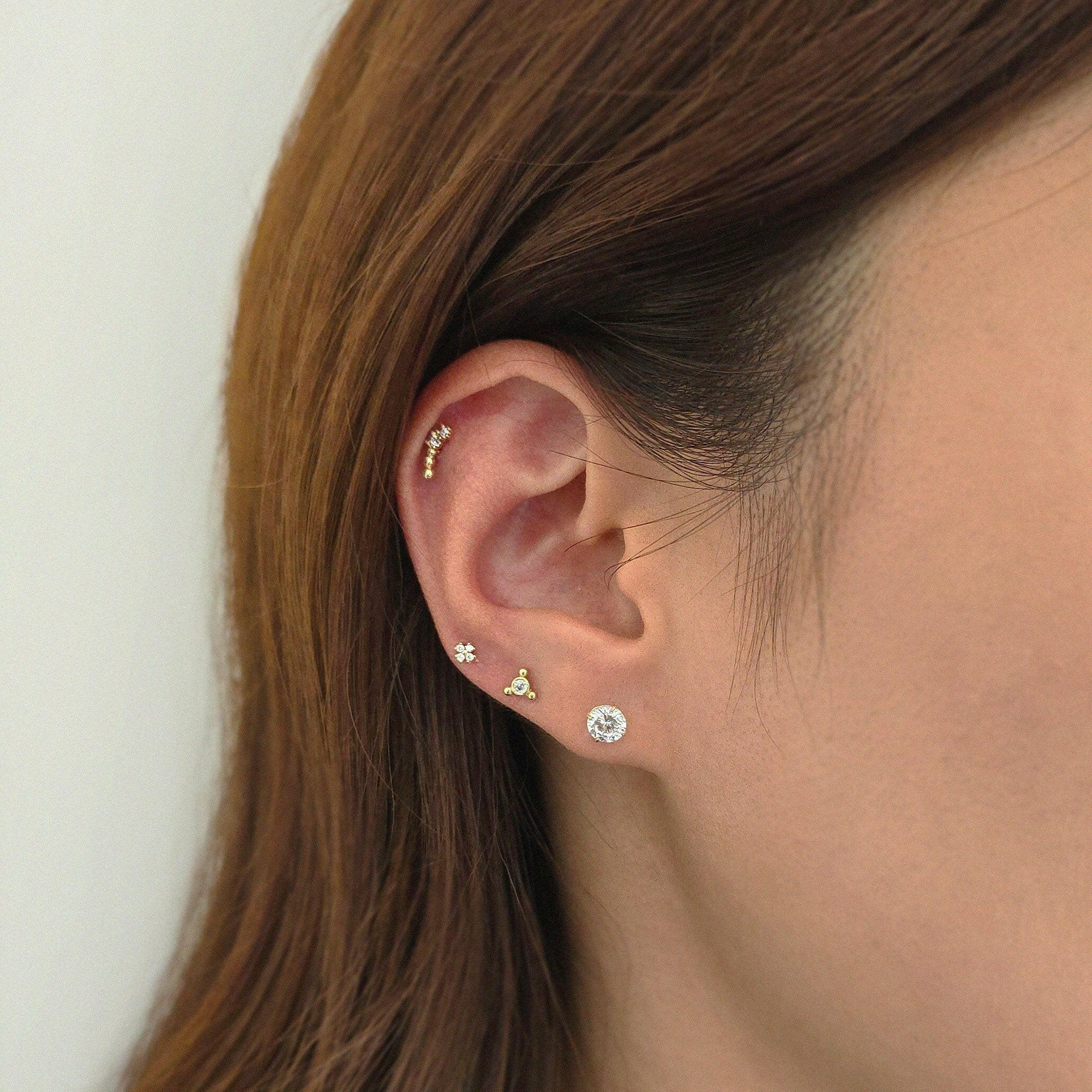 Multi-piercing look featuring Nebula as a delicate center point
