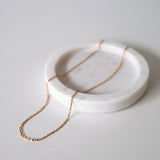 Close-up of minimalist chain structure and gold shine