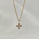 Macro shot of the La Cross Diamond Necklace highlighting the pavé-set diamonds.