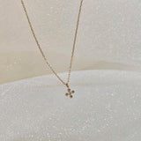 Side angle shot emphasizing the depth and polished finish of the cross pendant