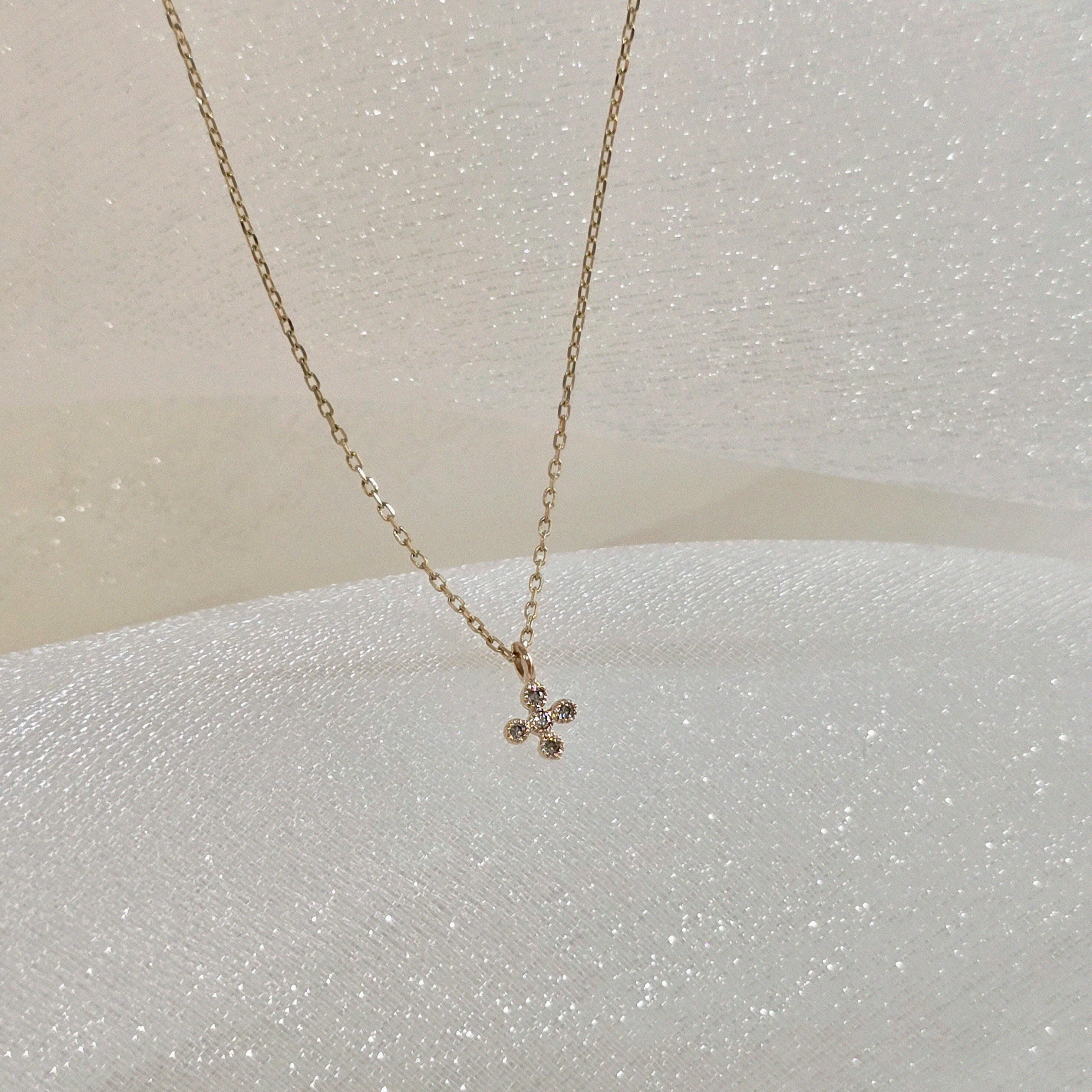 Side angle shot emphasizing the depth and polished finish of the cross pendant