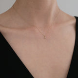Model wearing the La Cross Diamond Necklace with a black off-shoulder top, showcasing its refined elegance