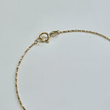 Detail shot of 14K gold clasp and luminous chain finish