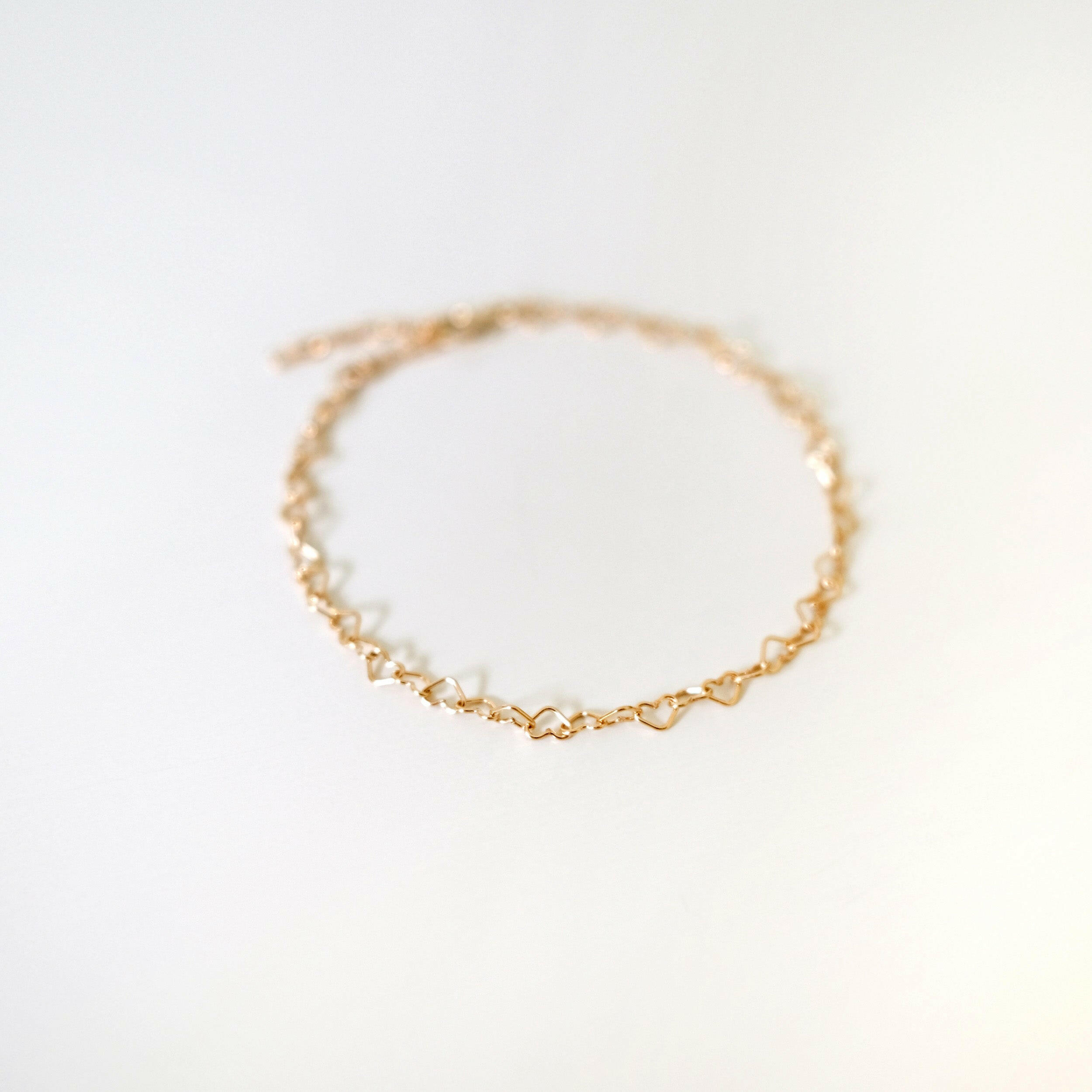 Aerial shot showing full heart-link chain structure and golden sheen